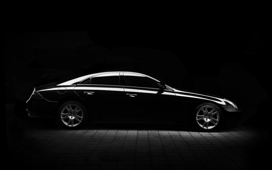 Silver luxury vehicle in a dark studio